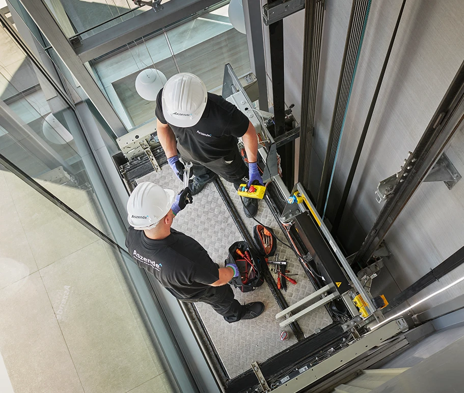 Operarios realizando obras de accesibilidad para instalar un ascensor en un edificio